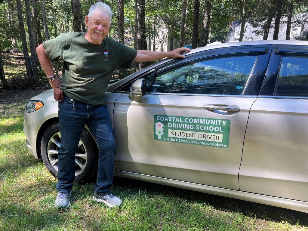Gary Boyd next to the student driver car
